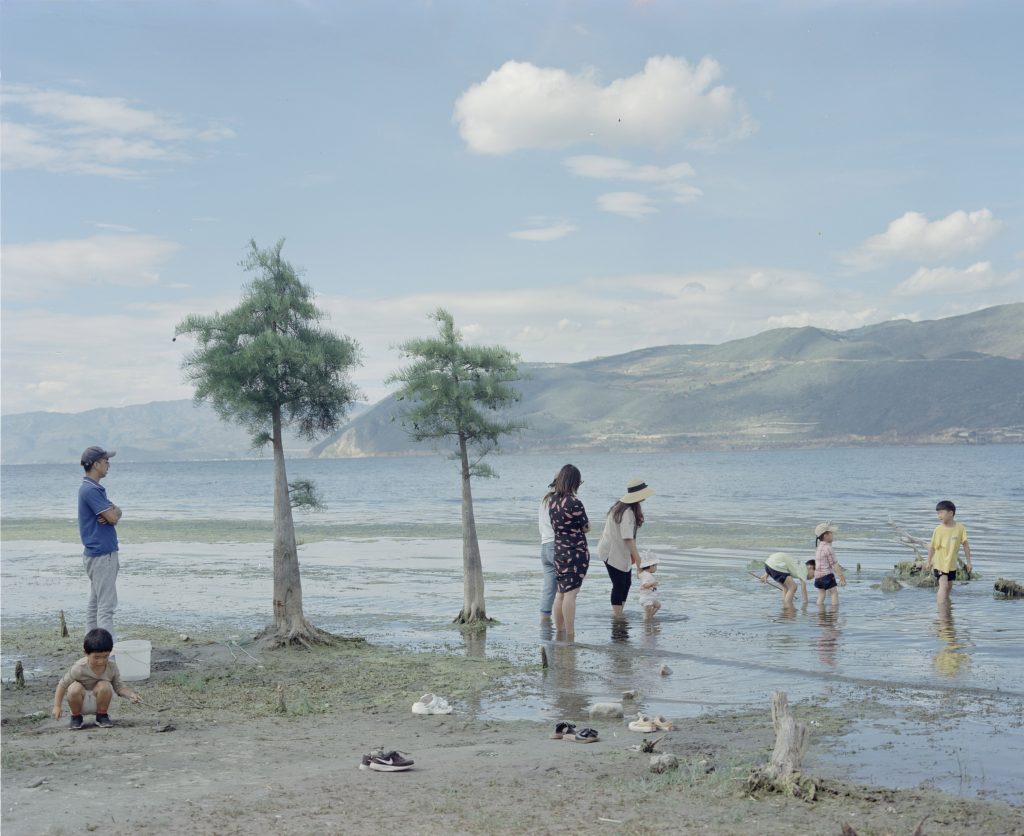 Lakeside scene with people and trees